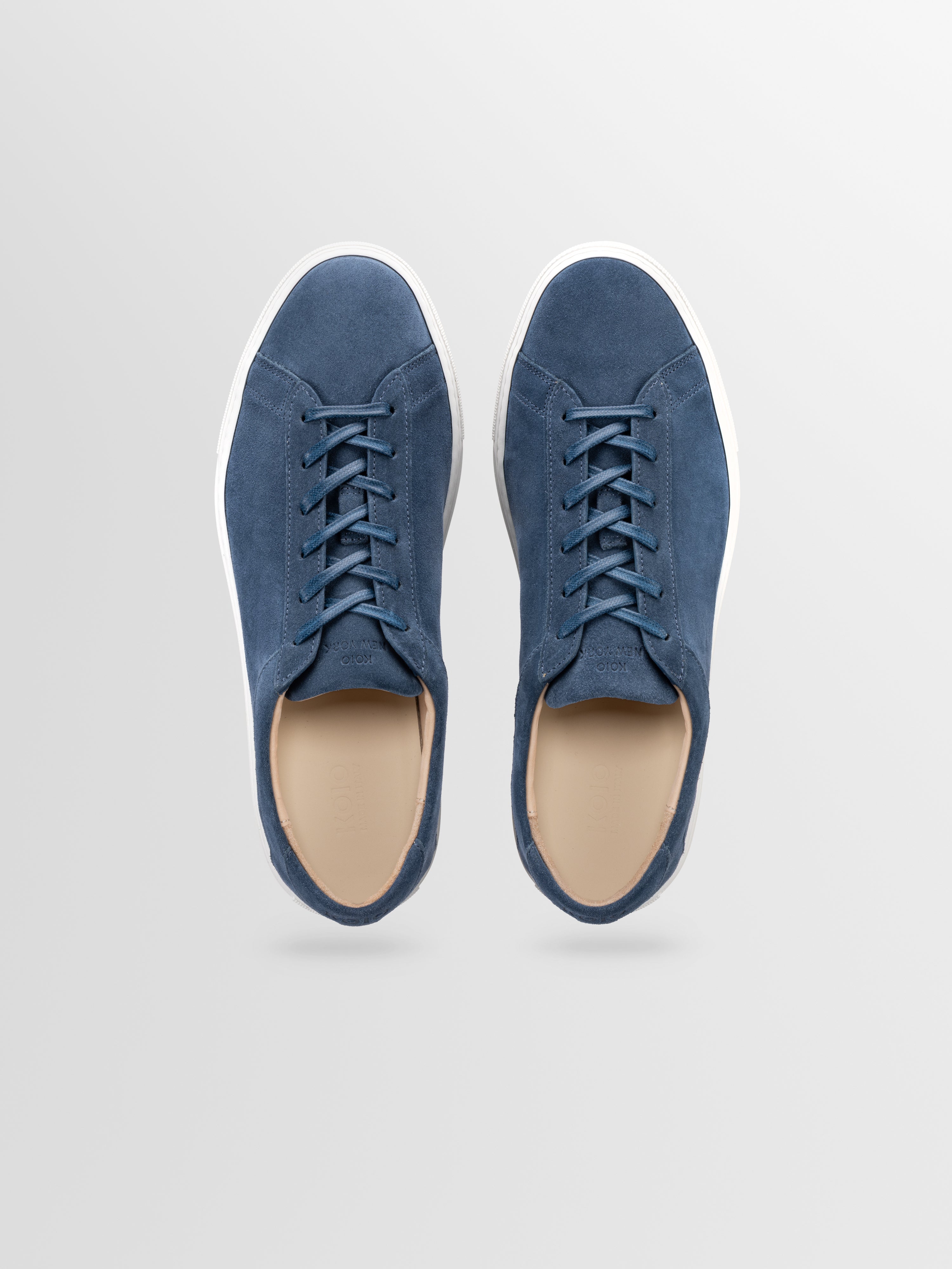 Blue suede sneakers with matching laces and white rubber soles