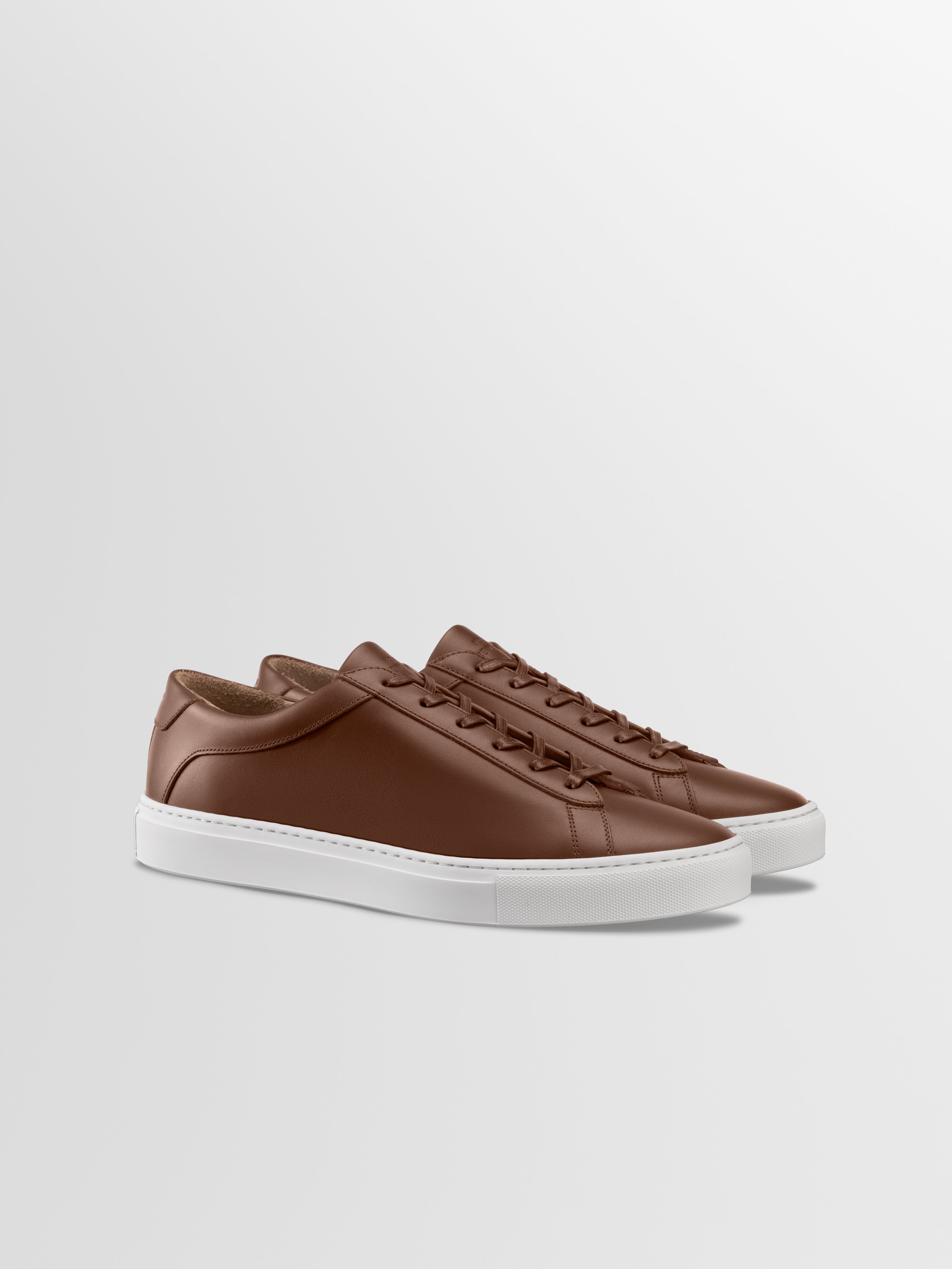 Brown leather sneakers with matching laces and white rubber soles
