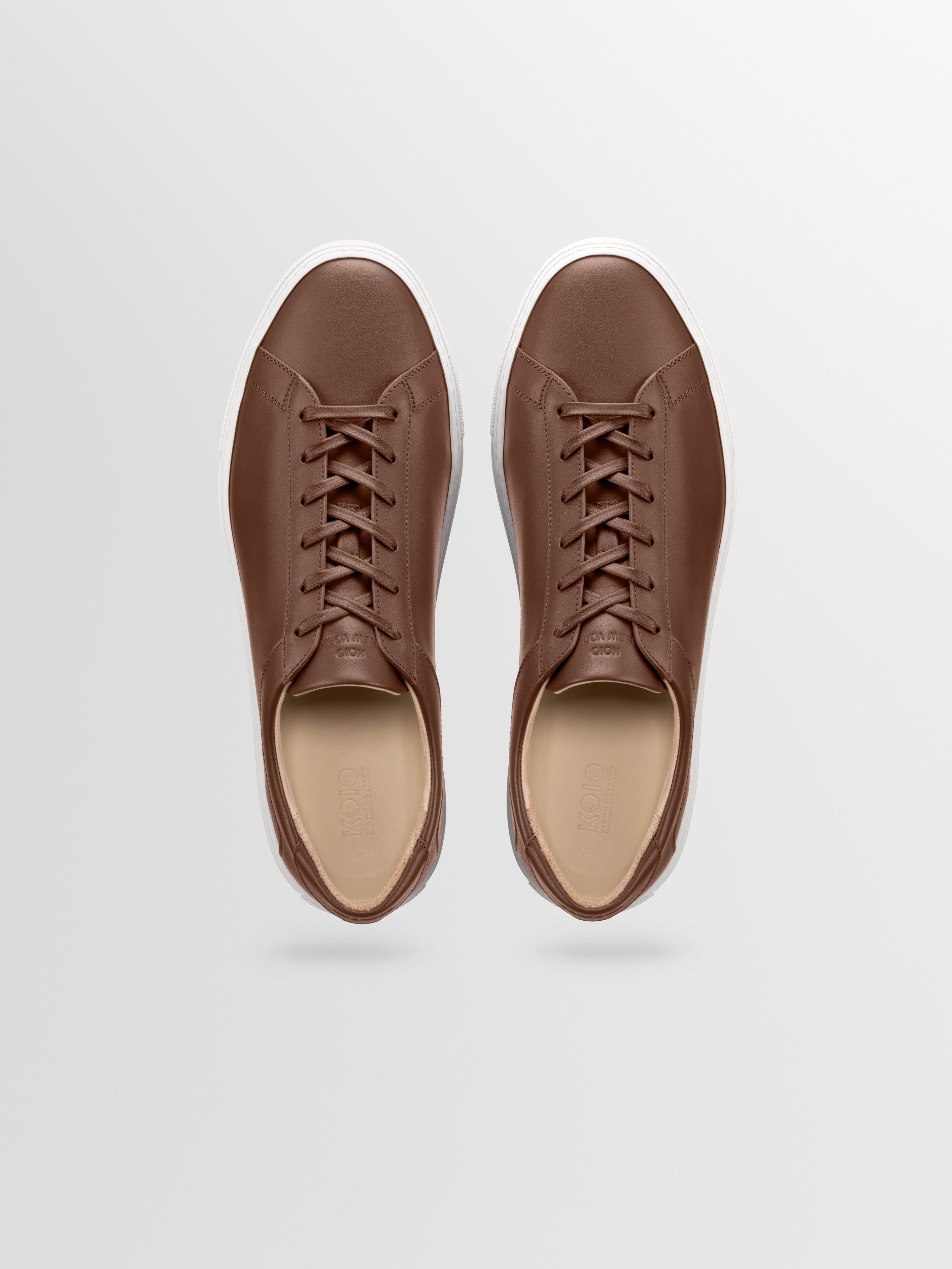 Brown leather sneakers with matching laces and white rubber soles