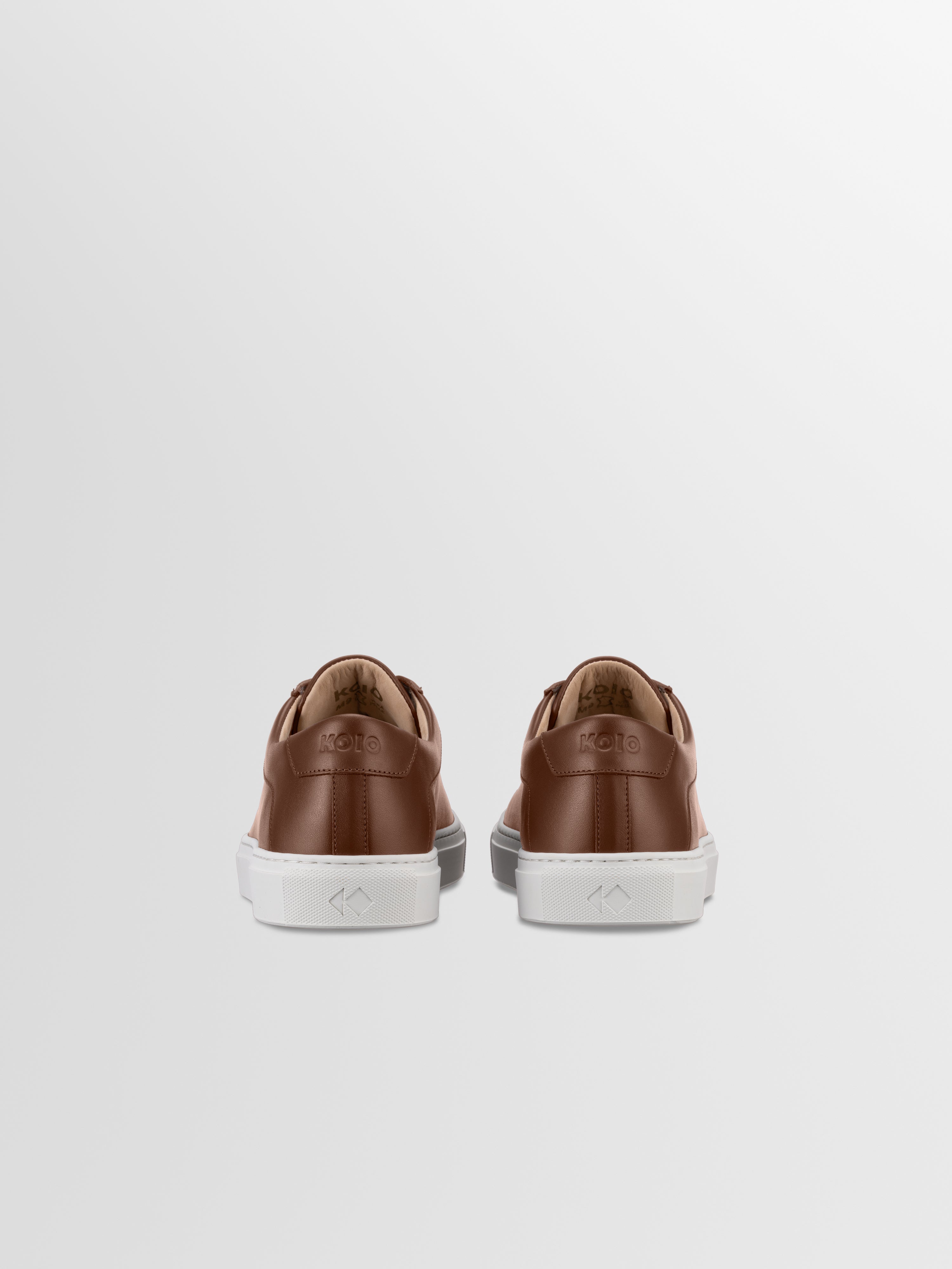 Brown leather sneakers with matching laces and white rubber soles