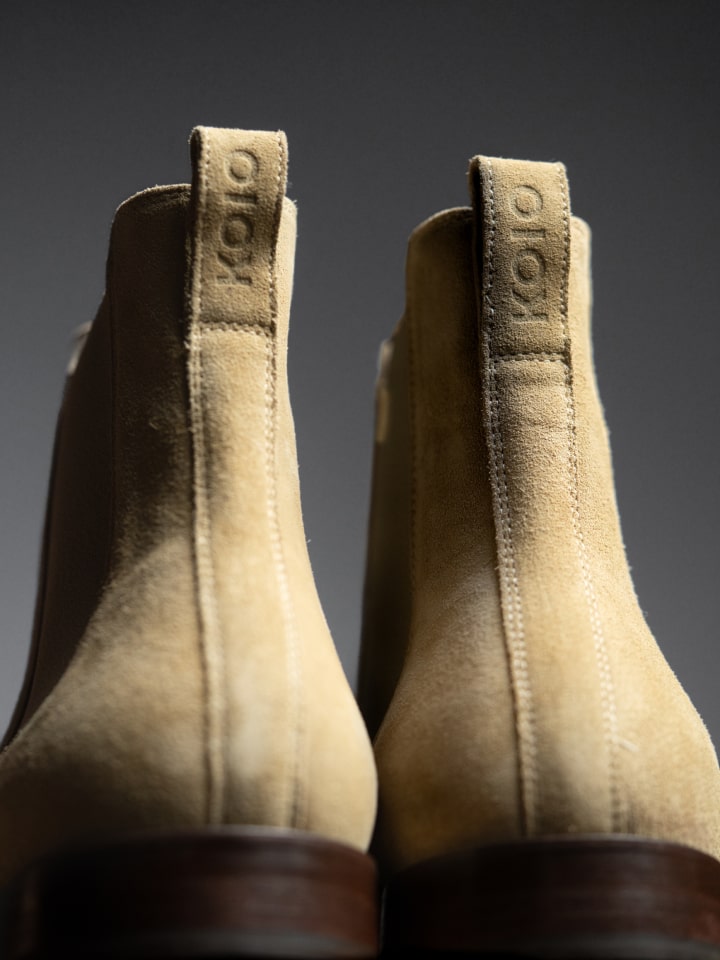 Close-up of men's Italian beige suede leather boots