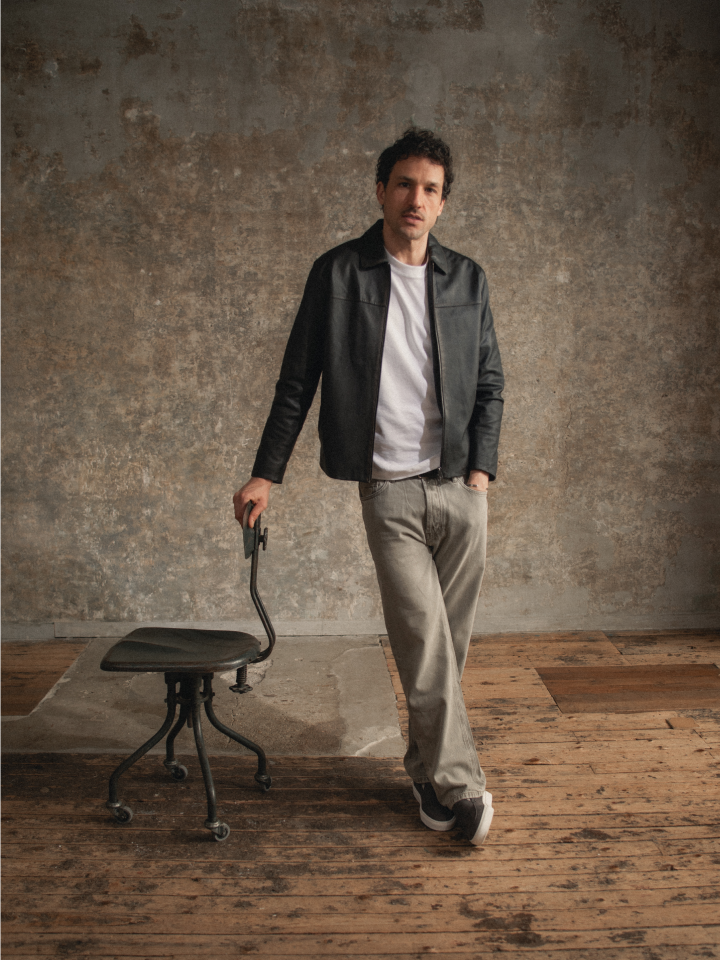 Man standing wearing men's Italian brown suede leather loafer sneakers with white rubber soles