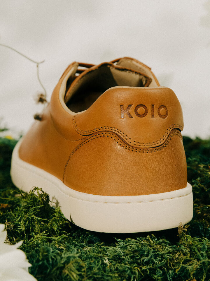 Close-up of men's italian brown leather sneaker with Koio logo and beige rubber soles