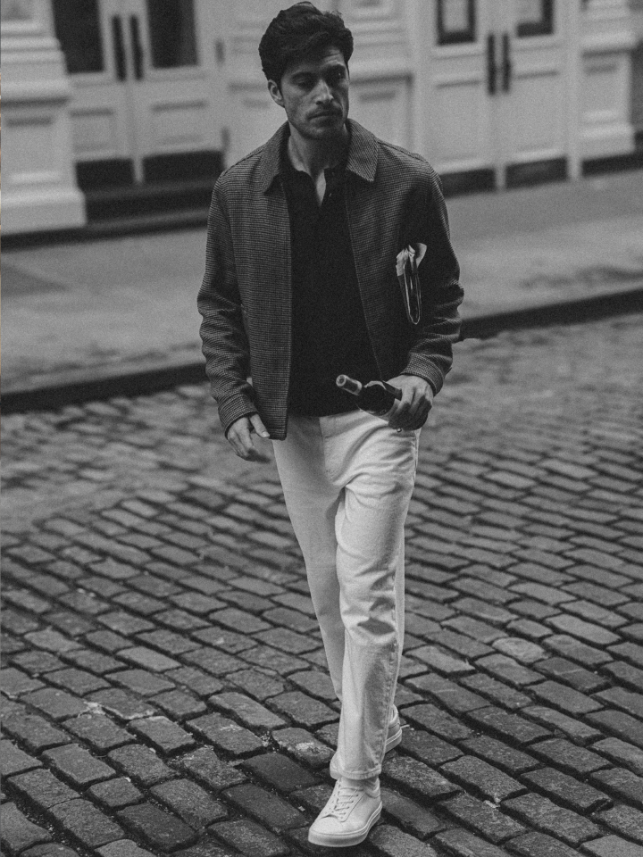 Man walking wearing men's Italian white leather sneakers with laces